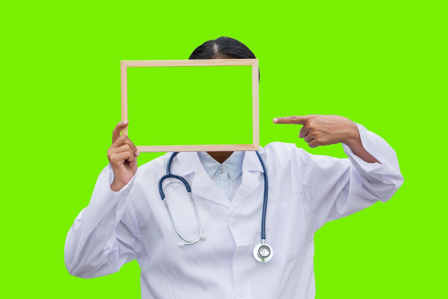 professional female doctor in white coat over white isolated background and Pointing to green blank board. Concept of healthcare, science and medicine concept photo