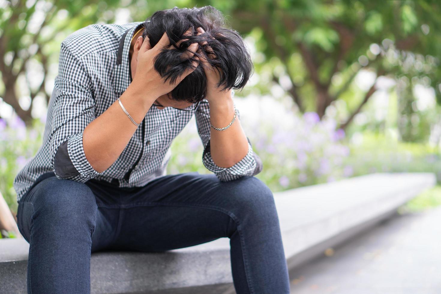 Negative emotion facial expression feelings. Stressed Asian businessman in depression with hands-on forehead because of work problems And was fired. photo