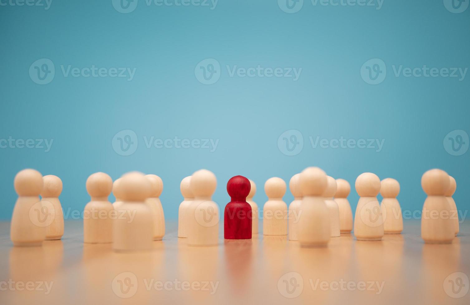 Wooden figure standing with team to show influence and empowerment. Concept of business leadership for leader team, successful competition winner and Leader with influence photo