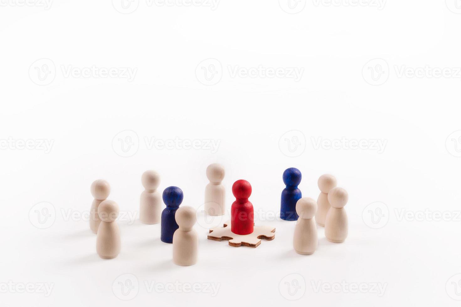 Wooden figure standing on the Jigsaw showing that it is an important part. Concept of business leadership for leader team, successful competition winner and Leader with influence photo