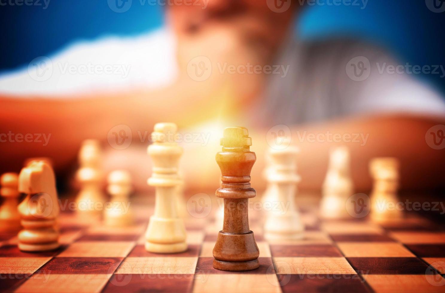 Selective focus of brown king chess and background of businessman thinking strategy and competitor evaluation in competition. Concept of leadership, business strategy. photo