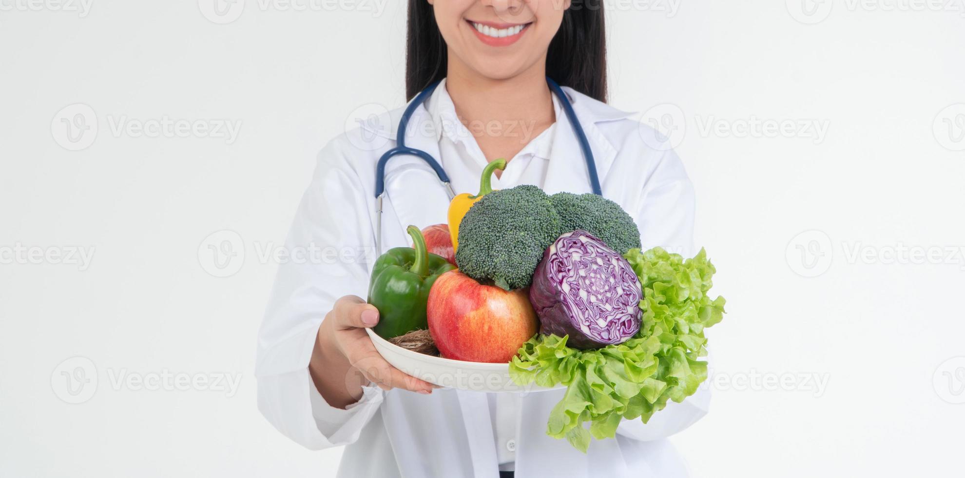 Doctor or nutritionist holding fresh fruit Orange, red and green apples and smile in clinic. Healthy diet Concept of nutrition food as a prescription for good health, fruit is medicine photo