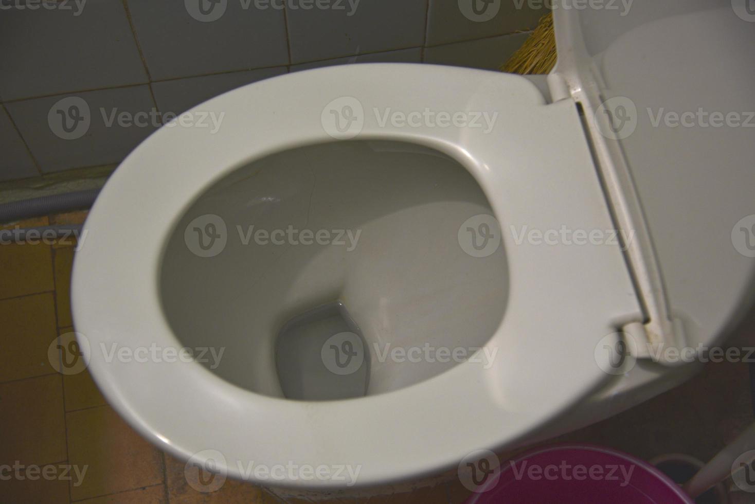 A white toilet in the bathroom. Toilet and cistern. The restroom. photo