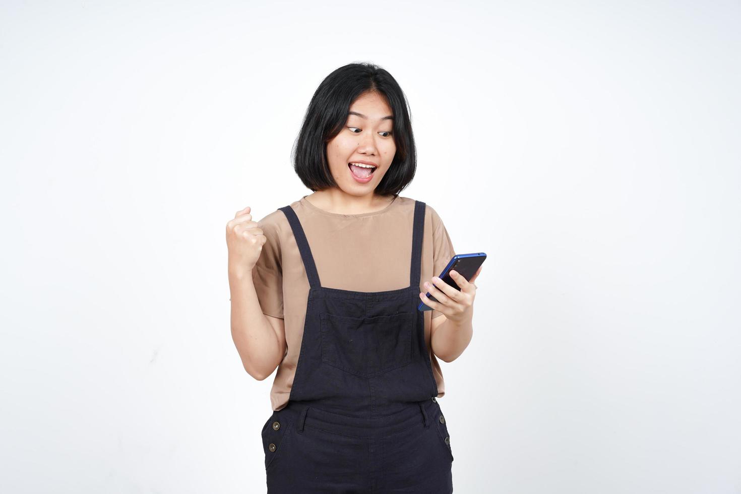 Using Smartphone with yes celebration gesture Of Beautiful Asian Woman Isolated On White Background photo