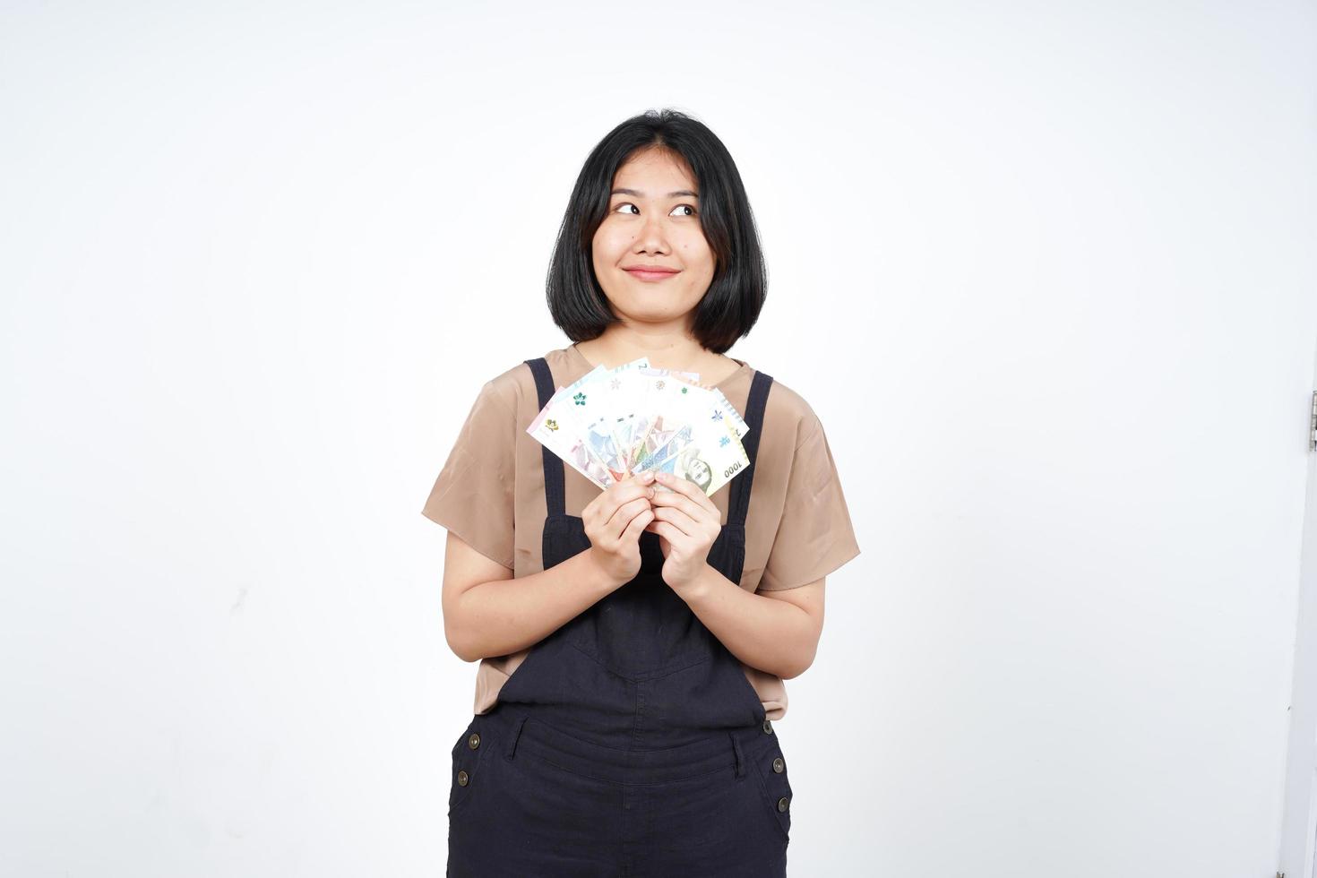 Holding Indonesia New Banknote Of Beautiful Asian Woman Isolated On White Background photo