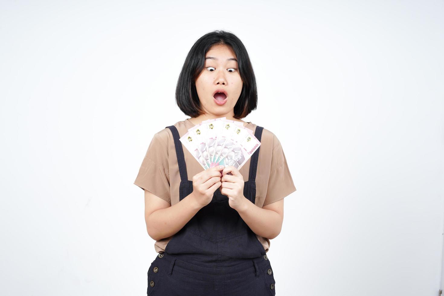 Holding Indonesia New 100.000 Banknote Of Beautiful Asian Woman Isolated On White Background photo