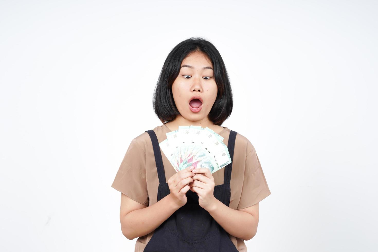 Holding Indonesia New Banknote Of Beautiful Asian Woman Isolated On White Background photo