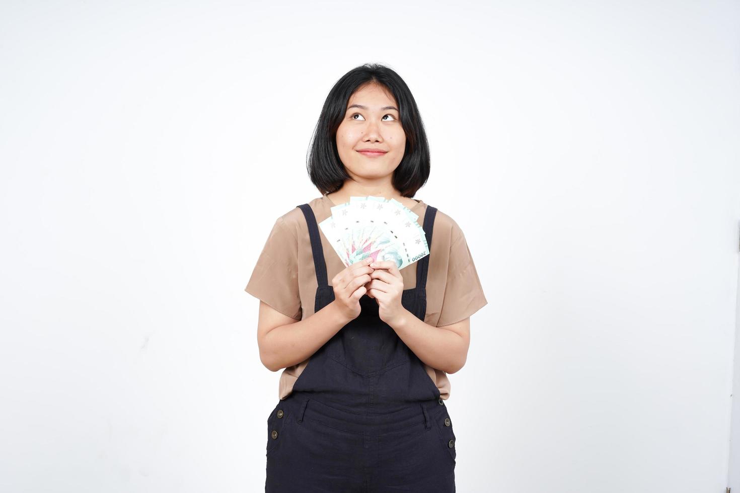 Holding Indonesia New Banknote Of Beautiful Asian Woman Isolated On White Background photo