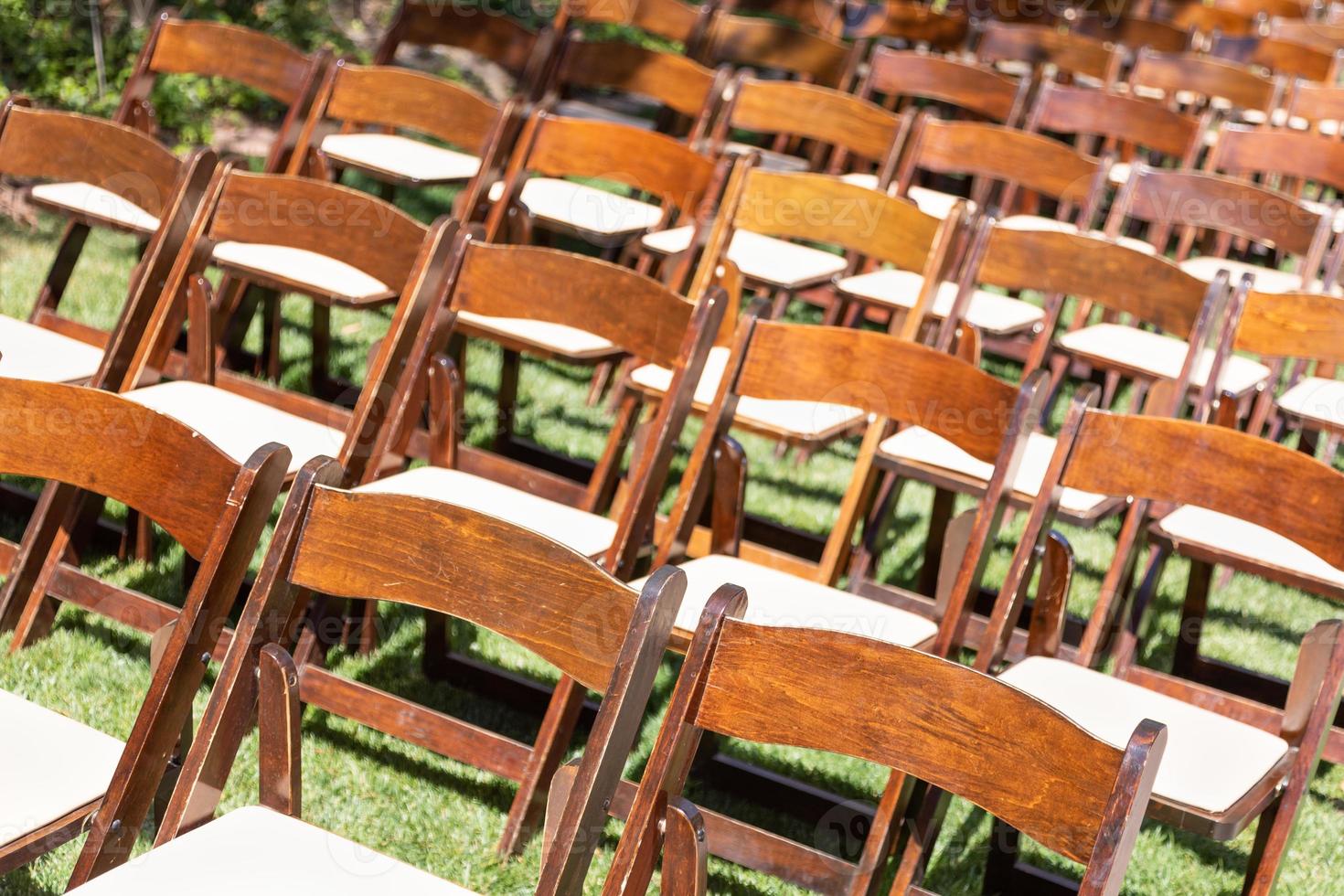 Rows of Wooden Event Chairs at Wedding Venue Abstract. photo