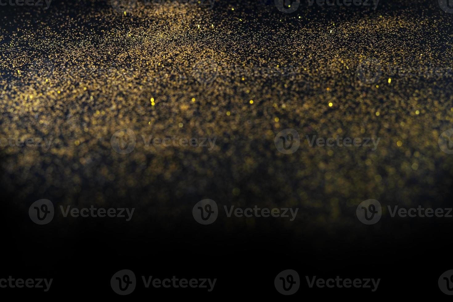 Dark texture with a sprinkling of gold. Backdrop with golden sparkle for overlay photo effect filters. fancy, luxury, themed backgrounds.