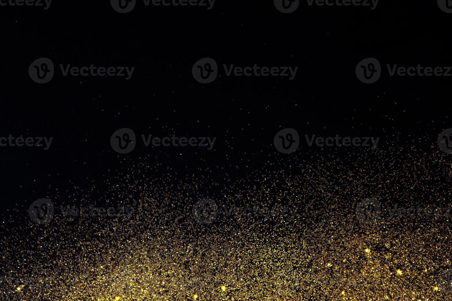 Dark texture with a sprinkling of gold. Backdrop with golden sparkle for overlay photo effect filters. fancy, luxury, themed backgrounds.