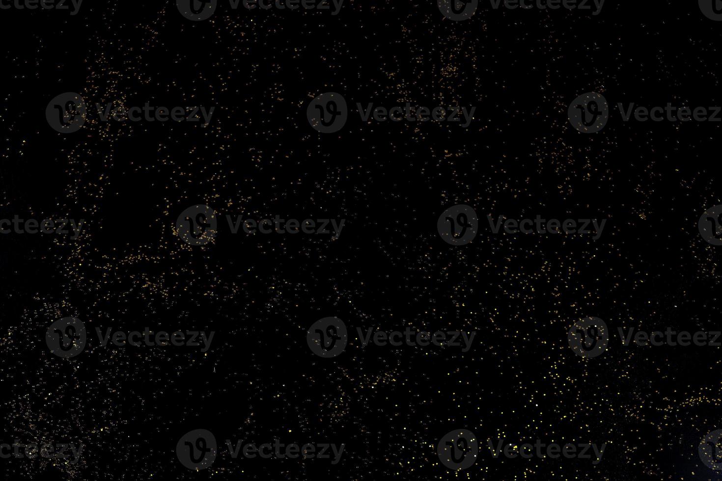 Dark texture with a sprinkling of gold. Backdrop with golden sparkle for overlay photo effect filters. fancy, luxury, themed backgrounds.