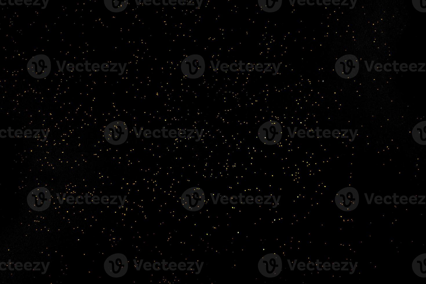 Dark texture with a sprinkling of gold. Backdrop with golden sparkle for overlay photo effect filters. fancy, luxury, themed backgrounds.