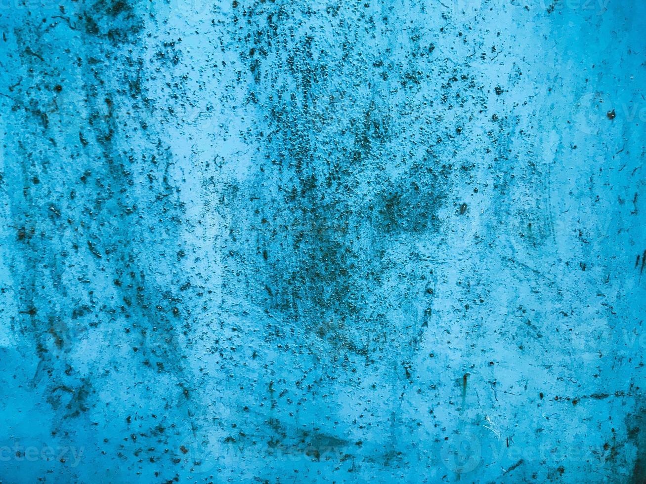 texture in blue. bright, shiny surface of unusual color. metal sheet with paint smudges, damage, corrosion and rust. texture is heterogeneous, smooth, volumetric photo