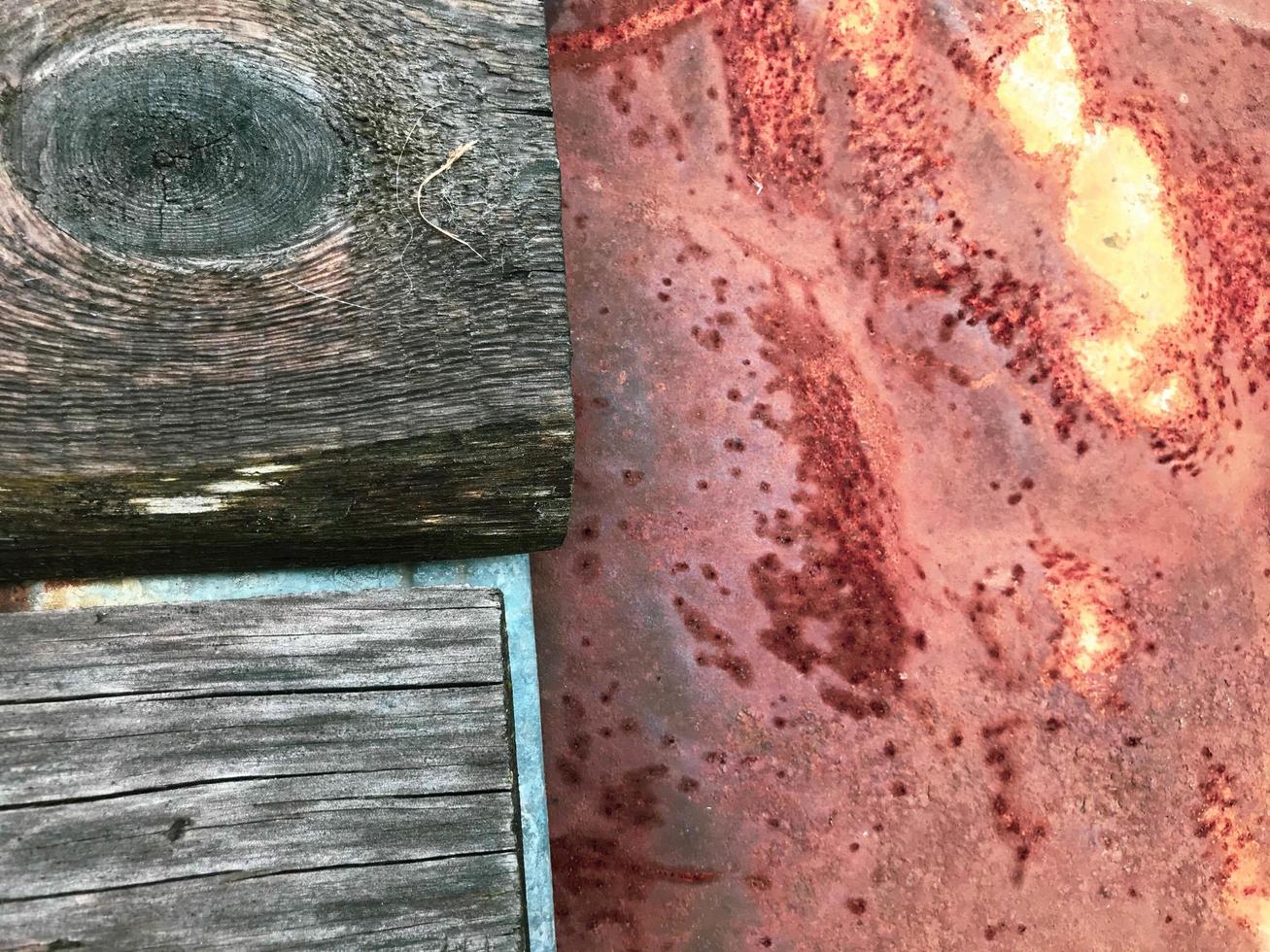metal and wood texture. a strip of gray wood with a round hole lies next to a corroded sheet of metal. two materials, home creation. texture of natural materials photo