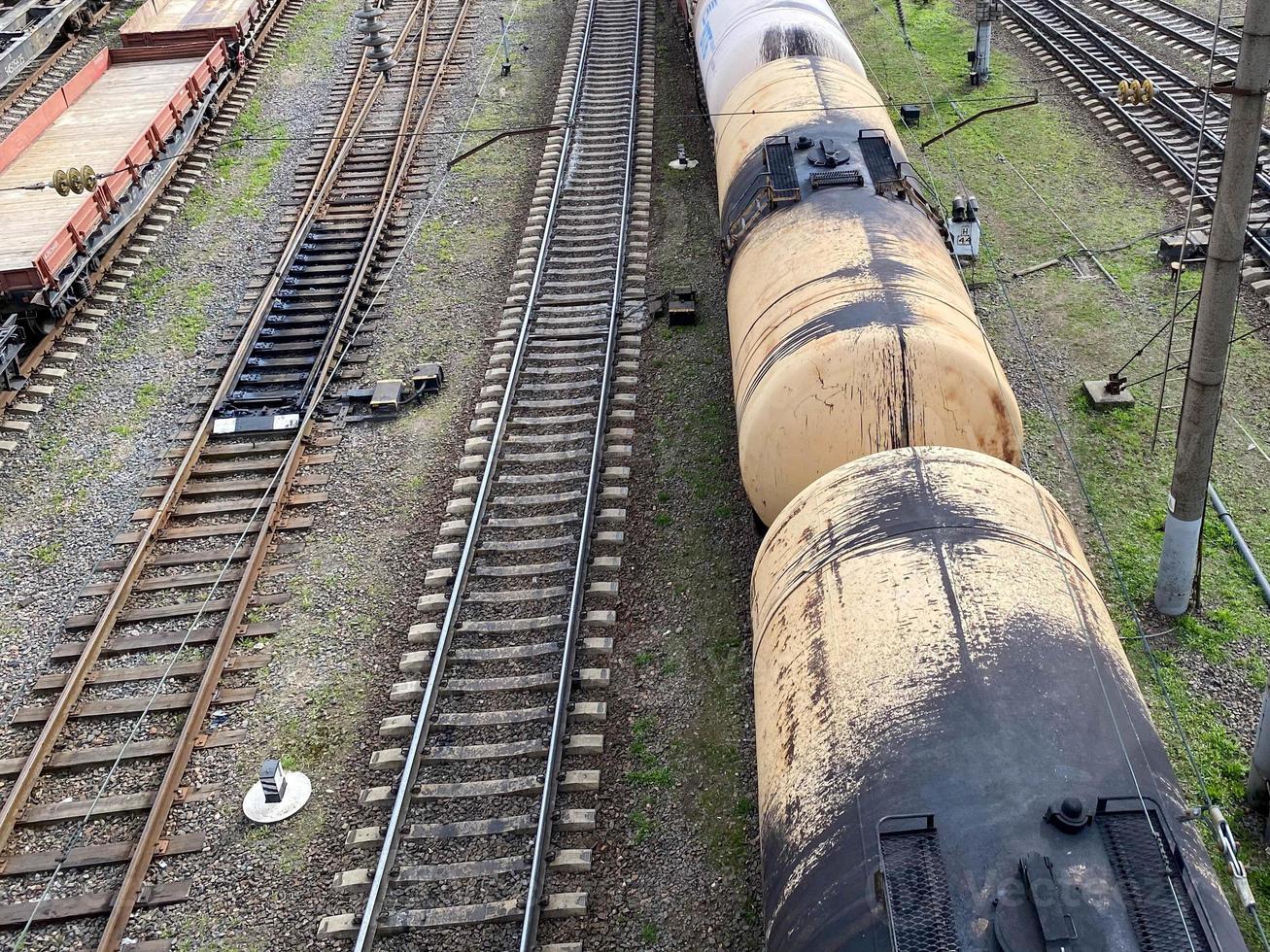 Top view of different railway wagons and tanks on an industrial railroad with rails for the transport of goods and improved modern logistics photo