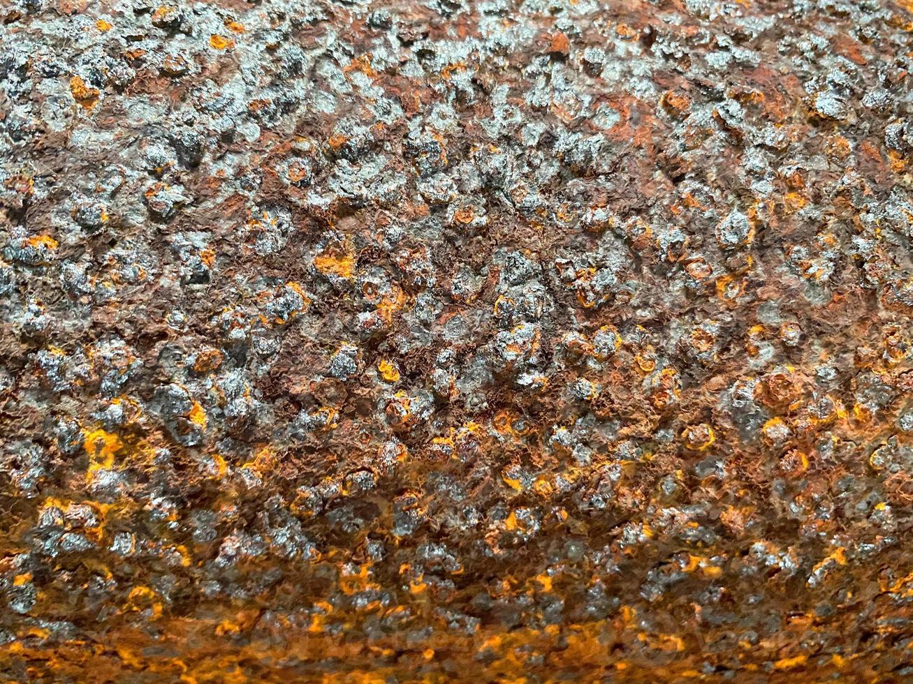 Surface texture of old metal iron swollen reddish orange surface of rusty bad pipe. Close view. The background photo