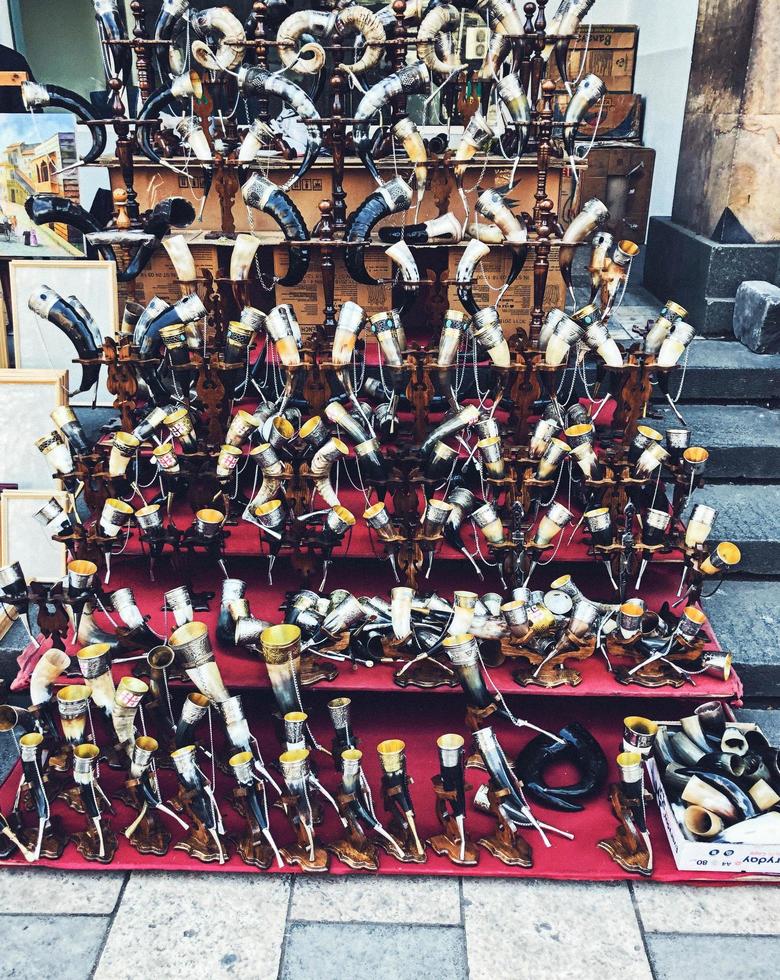 A store shelf with many traditional horns, wine and alcohol horns photo