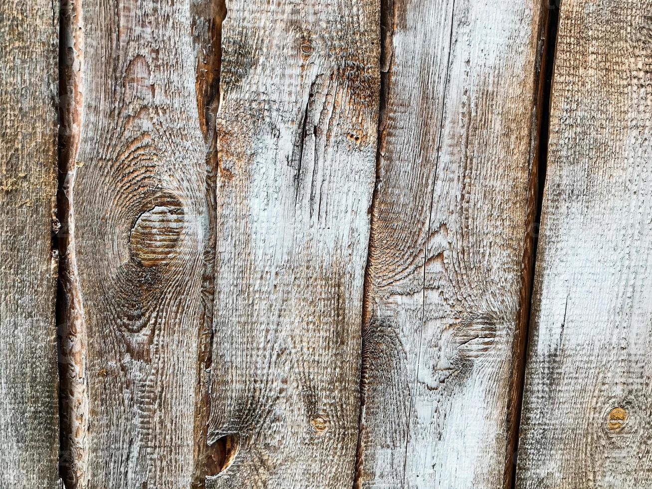 texture, natural background. wood texture, brown irregular background. brown wood, painted with paint, voluminous, non-uniform. wooden fence with holes photo