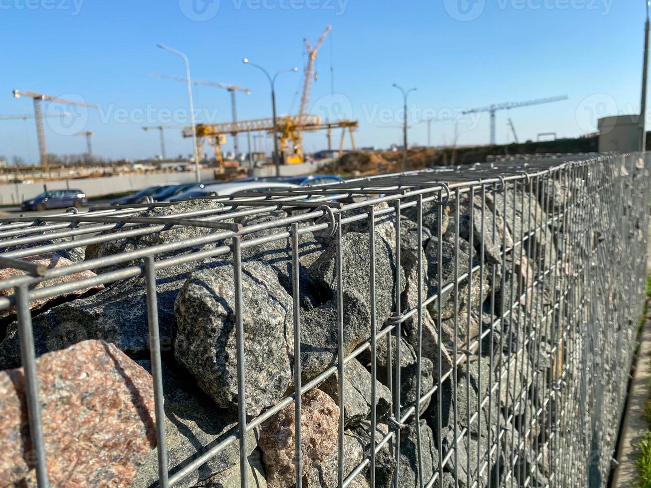 Iron metal mesh reinforcement on a concrete wall in the construction of houses by industrial methods with the help of cranes photo