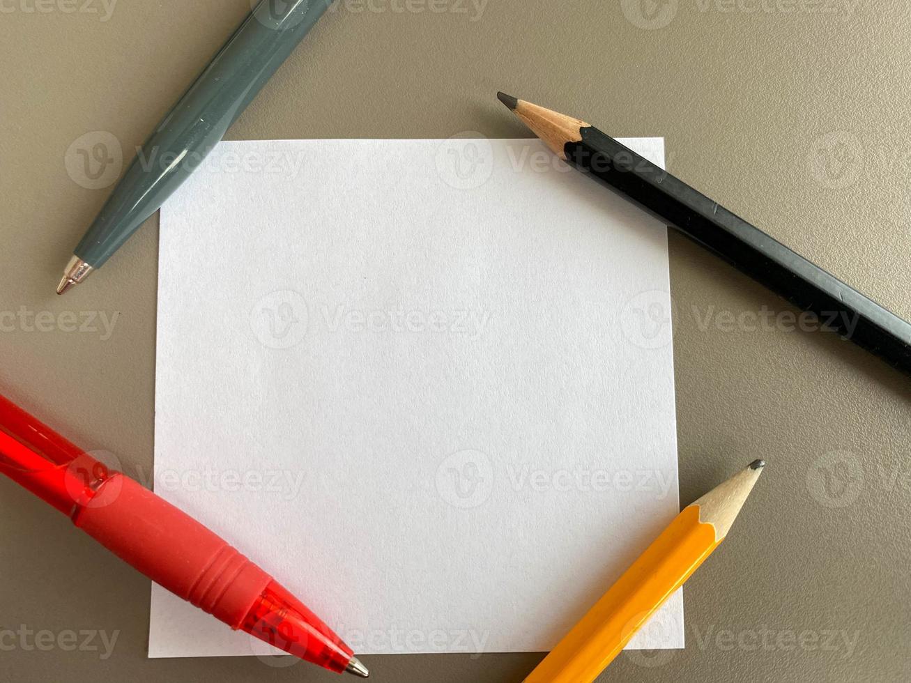 Small square pieces of paper for notes and notes on the office desk and ballpoint pens with pencils. Business work photo