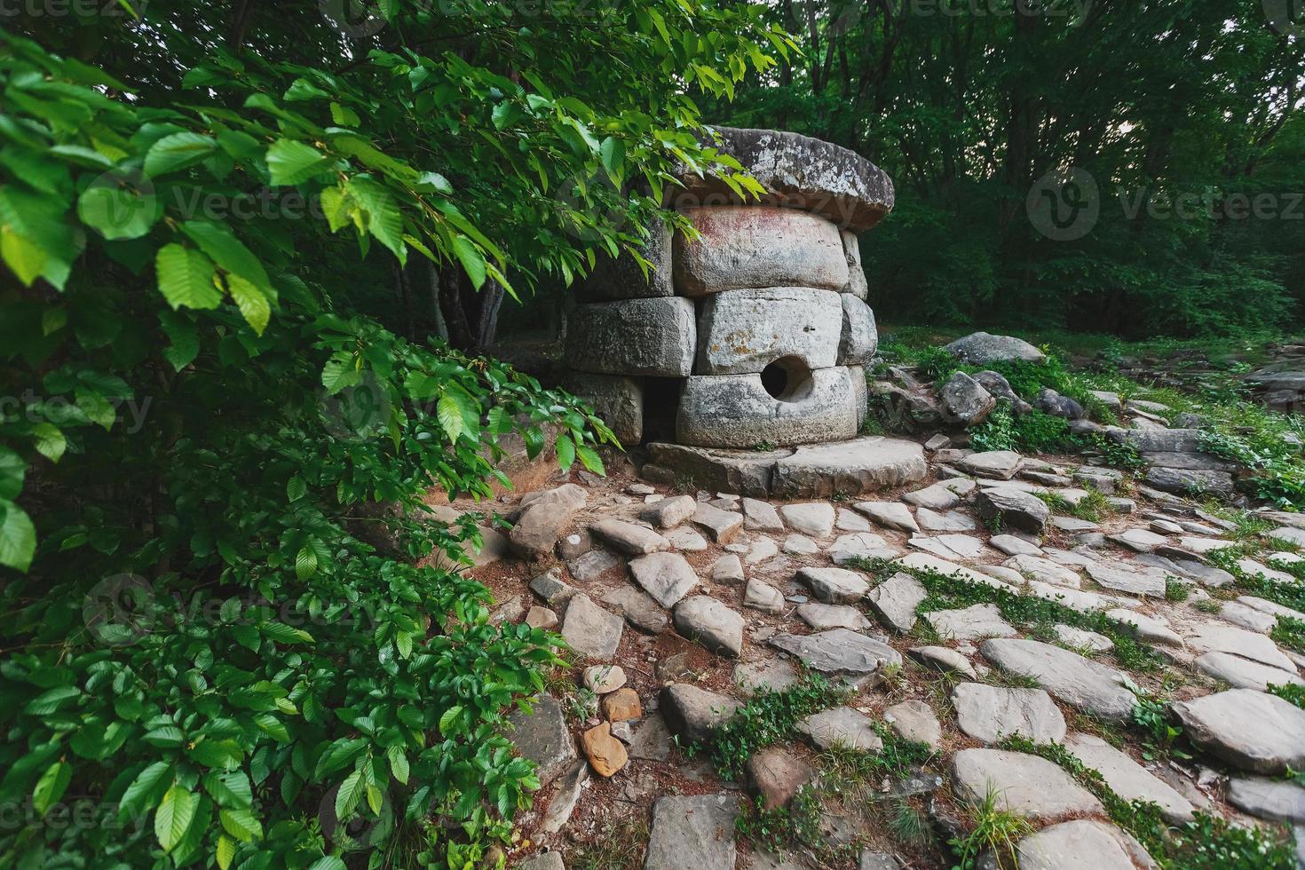 Ancient round compound dolmen in the valley of the river Jean, Monument of archeology megalithic structure. photo