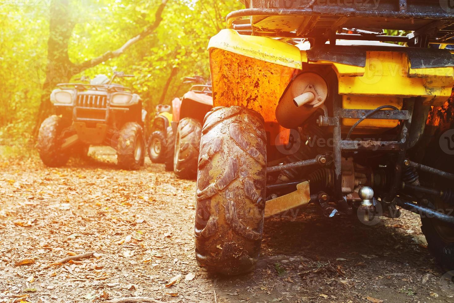 ATV in the forest, in the mud. Wheels and ATV elements close-up in the mud. Active leisure, sports and tourism. photo