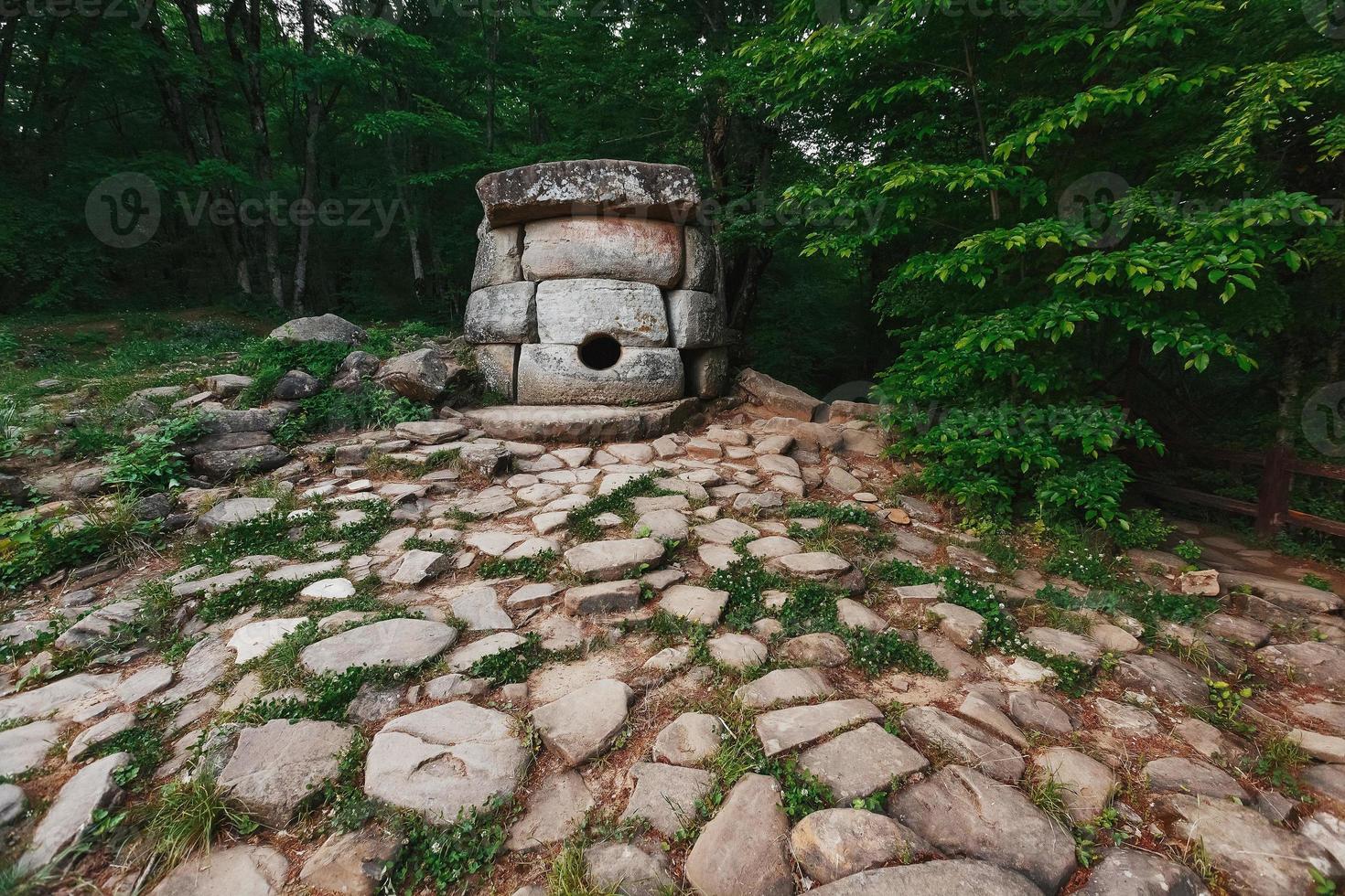 Ancient round compound dolmen in the valley of the river Jean, Monument of archeology megalithic structure. photo