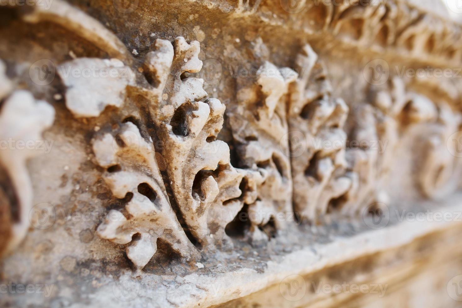 Beautiful and graceful ornament, an element of buildings. Parts of the ruins and ruins of ancient antiquity. photo