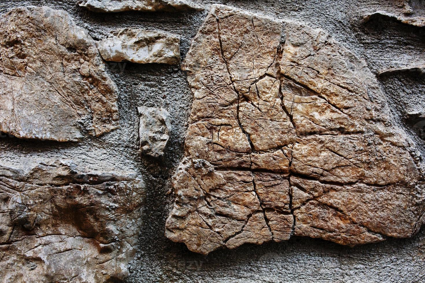 Textural background of cracked stone of an old castle. As a solid background photo