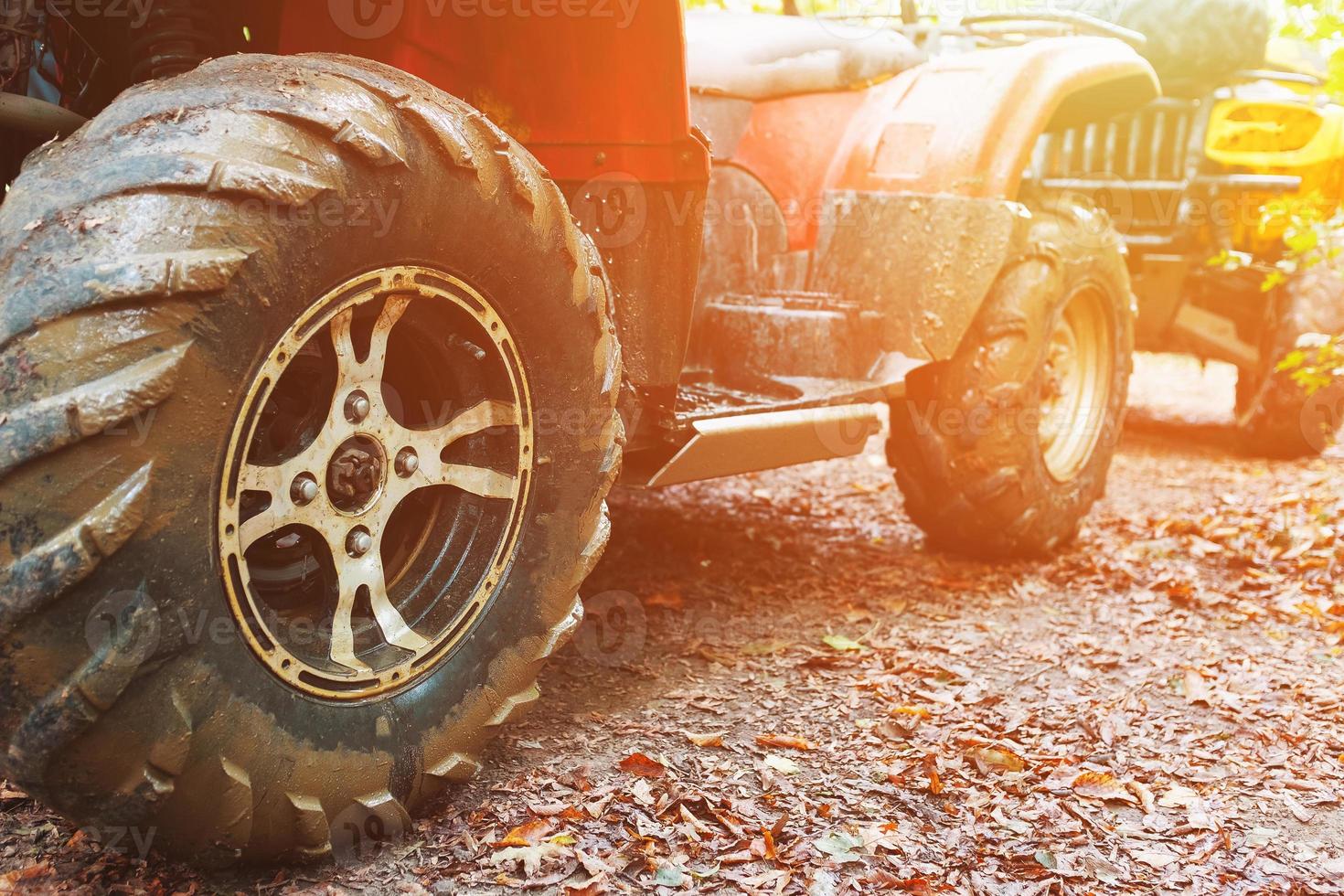 ATV in the forest, in the mud. Wheels and ATV elements close-up in the mud. Active leisure, sports and tourism. photo