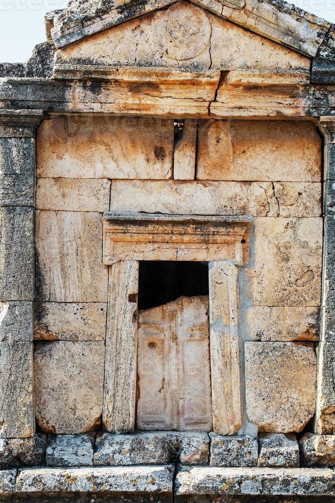 The front part of the crypt with the front door, the tomb in a large cemetery in Hierapolis. photo