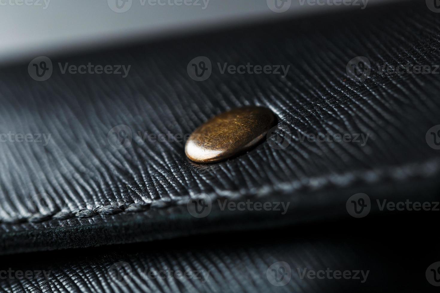 Black wallet made of genuine leather on a dark background. Handmade leather items photo