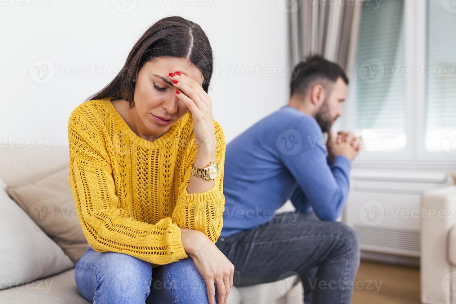 Unhappy thoughtful married couple spouses sitting separately on couch at home, wife husband not talking ignoring each other having problems in relationships, break up and divorce concept. photo