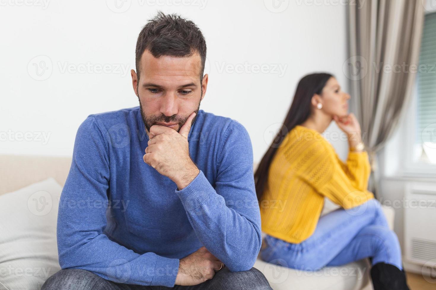 People, relationship difficulties, conflict and family concept - Unhappy couple having argument at home. Couple Having Argument At Home. Troubled woman expressing despair photo