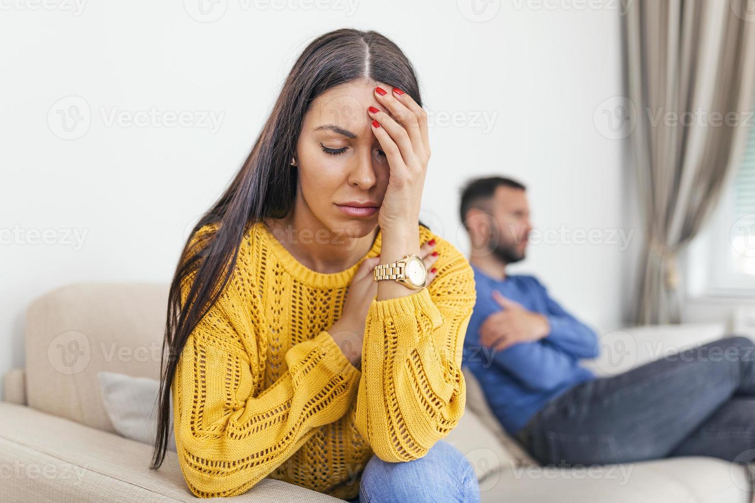 Couples who are fighting Disappointed in love. Concept for divorce. Couple not speaking to each other in livingroom. Young couple sitting on sofa being angry after fight. photo