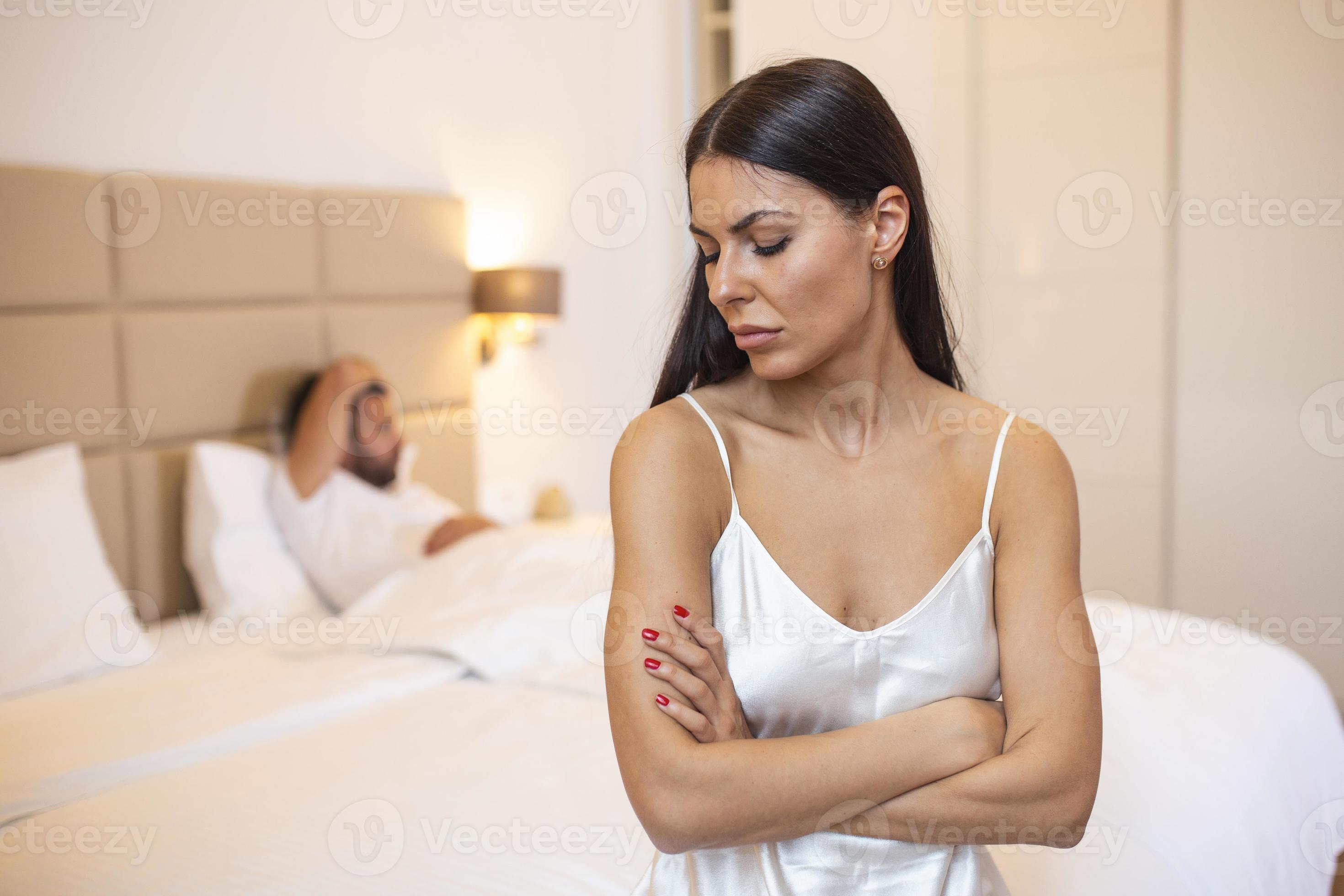 Young couple lying in bed under blanket in bedroom at home, man sleeping, pensive frustrated woman in lingerie thinking about relationships, cheat, treason, family having sexual problems close up 14445359 Stock Photo