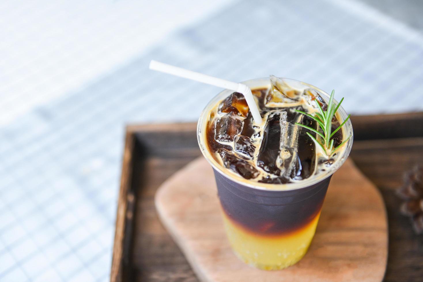 black coffee mix Orange syrup sparkling and rosemary - Iced americano Iced coffee with lemon orange juice and soda photo