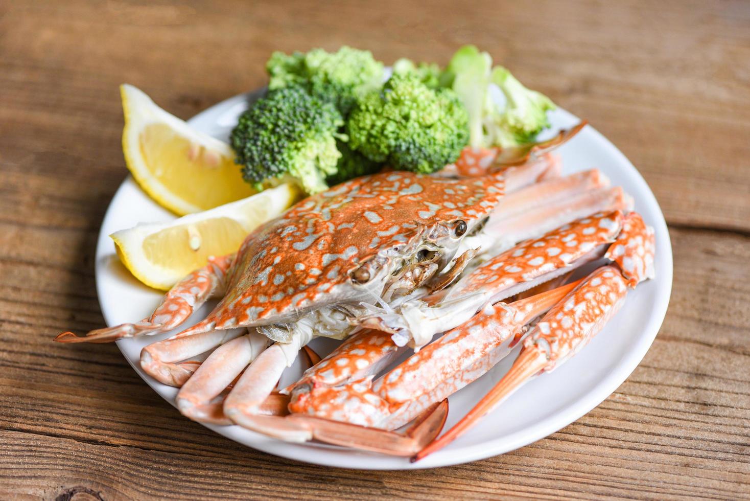 Boiled crab food on white plate seafood on the table - salad crab claws shellfish photo