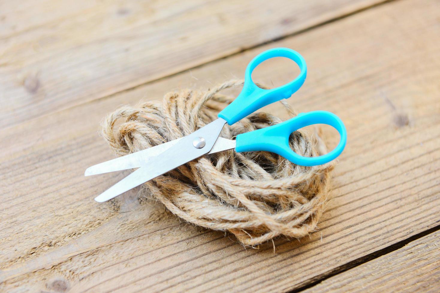 Rope and scissors on wooden background - Hemp rope or Natural rope photo