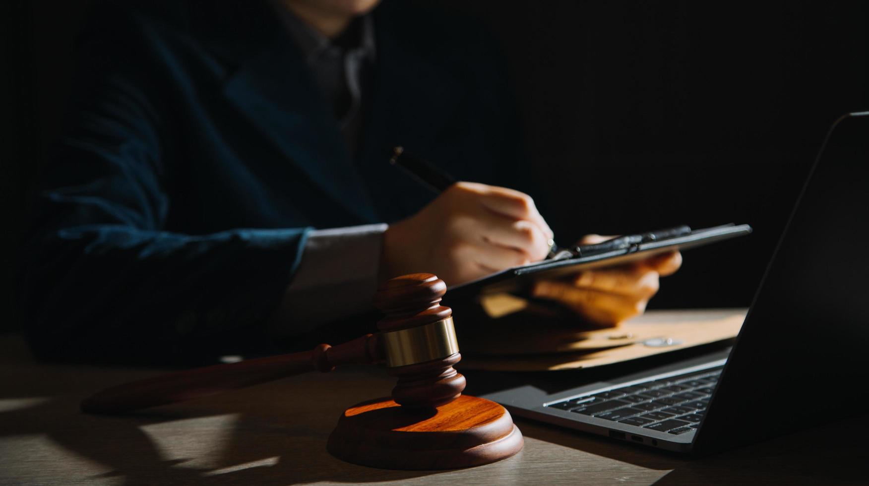 Business and lawyers discussing contract papers with brass scale on desk in office. Law, legal services, advice, justice and law concept picture with film grain effect photo