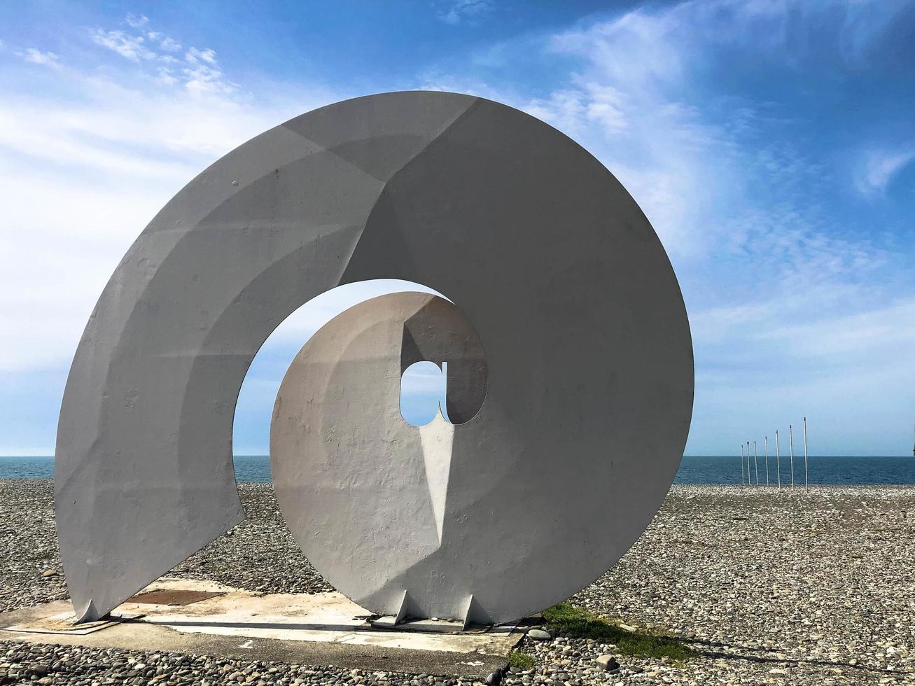Abstract statues, small architectural forms of a spiral, forms of bekonechnosti on Batumi Primorsky Boulevard or Batumi Beach. Georgia, Batumi, April 17, 2019 photo