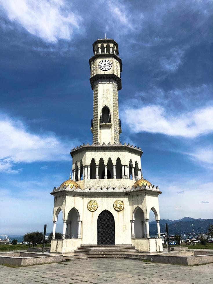 The 25-meter Oriental-style chacha Tower is made of light-colored stone with many arches and carved elements, with golden spheres and pools around 4 fountains. Batumi, Georgia, April 17, 2019 photo