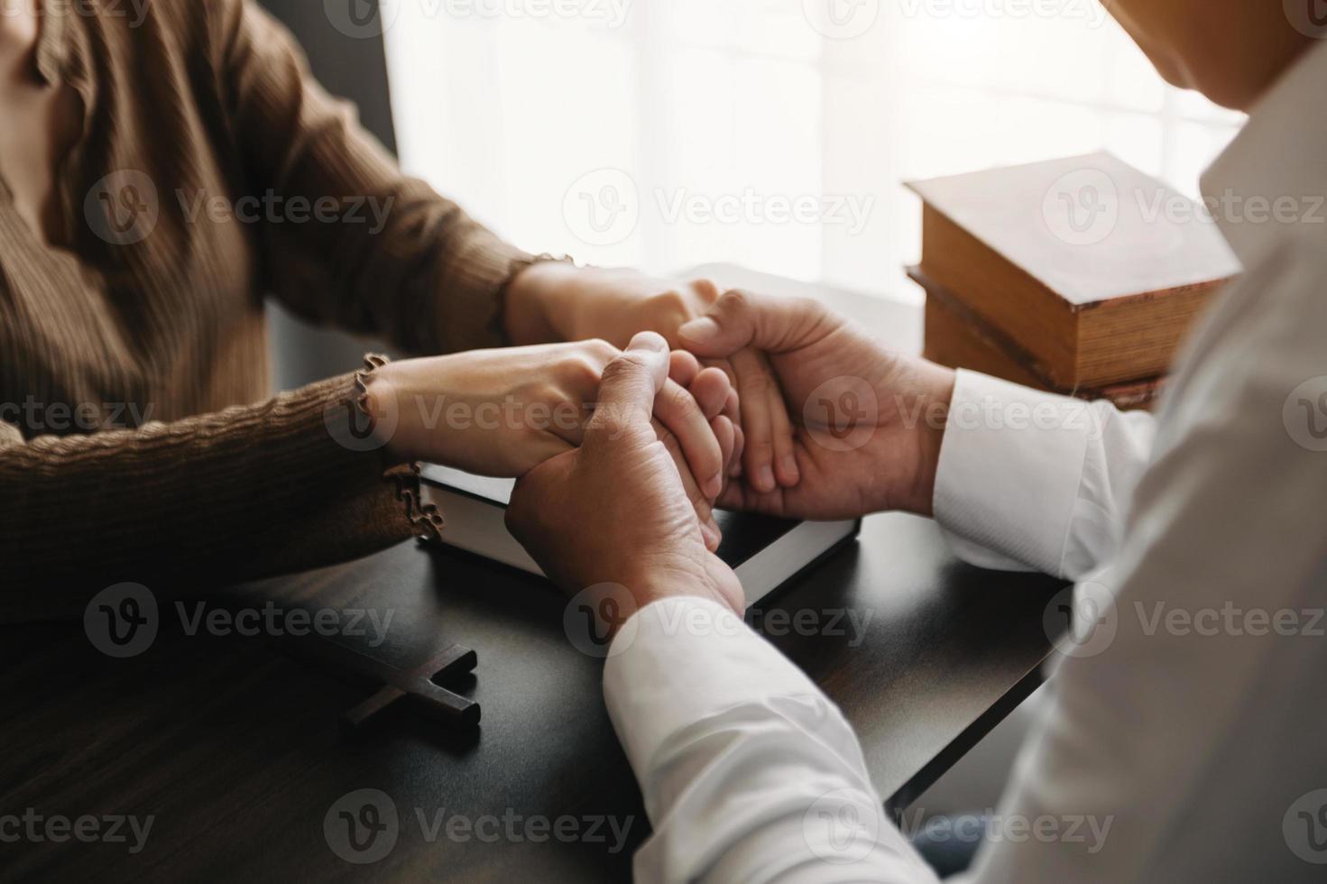 Woman's hand with cross .Concept of hope, faith, christianity, religion, church and pray to God. on the table photo