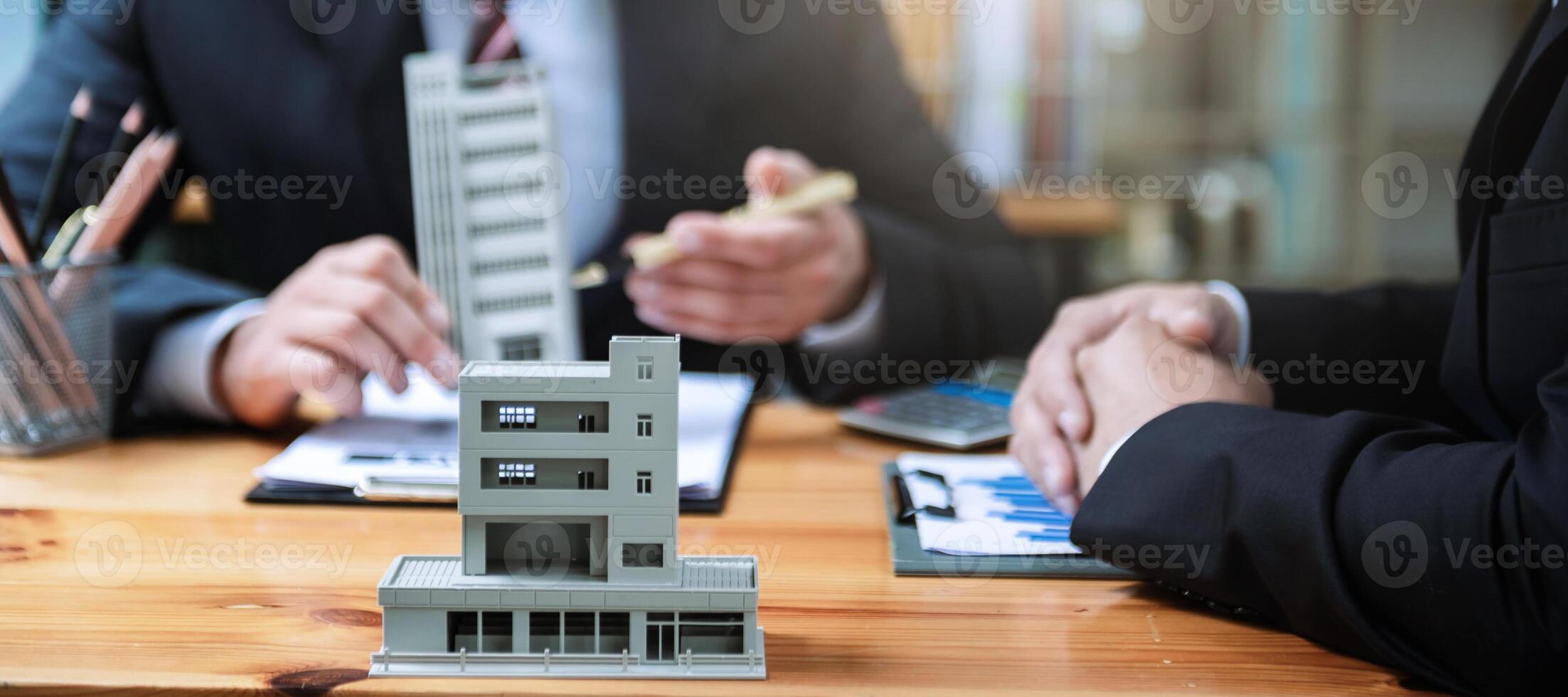 Signing a contract. Client and broker agent, lease agreement, successful deal and  Young business sitting at the desk in office photo