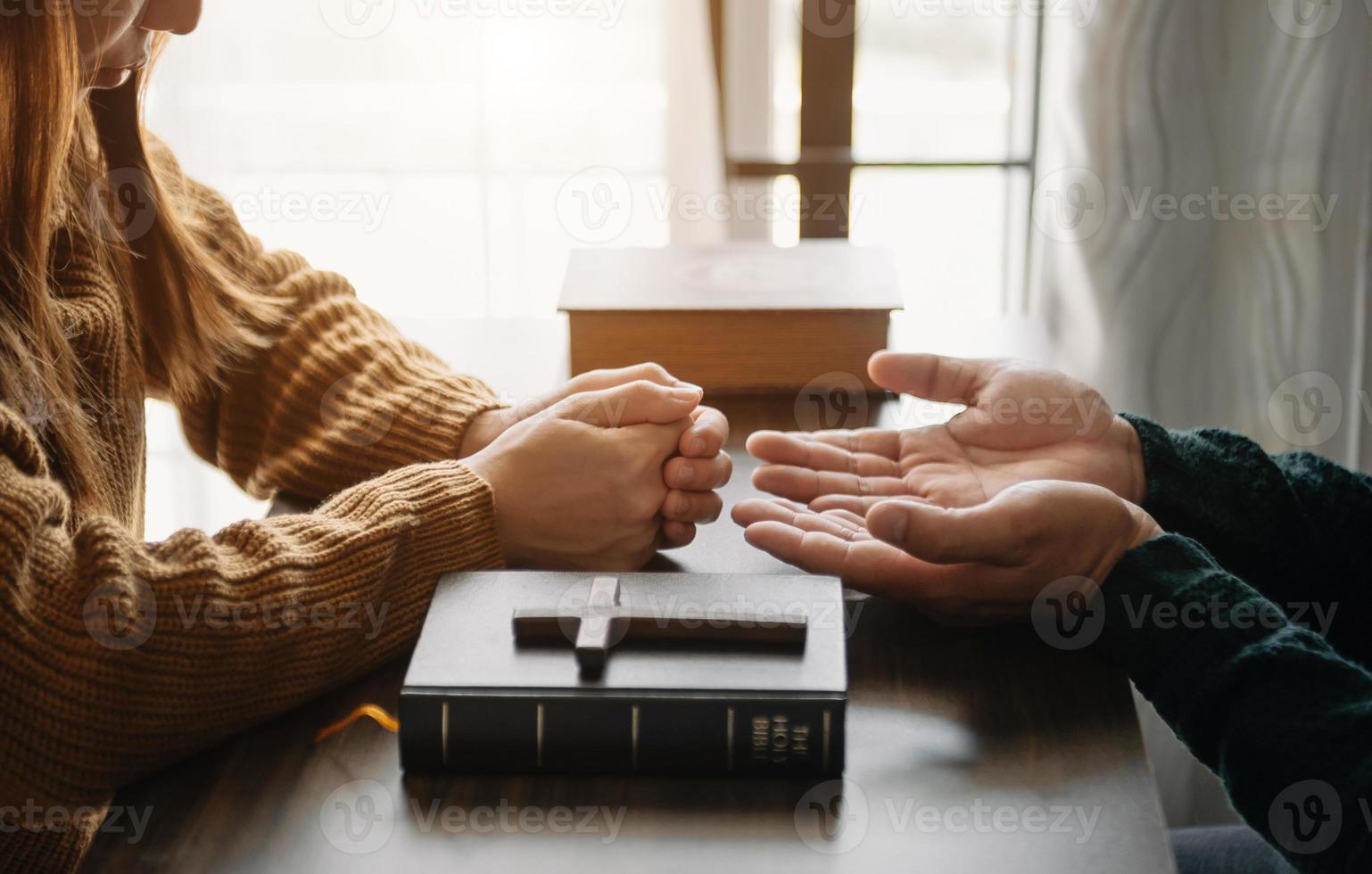 Woman's hand with cross .Concept of hope, faith, christianity, religion, church and pray to God. on the table photo