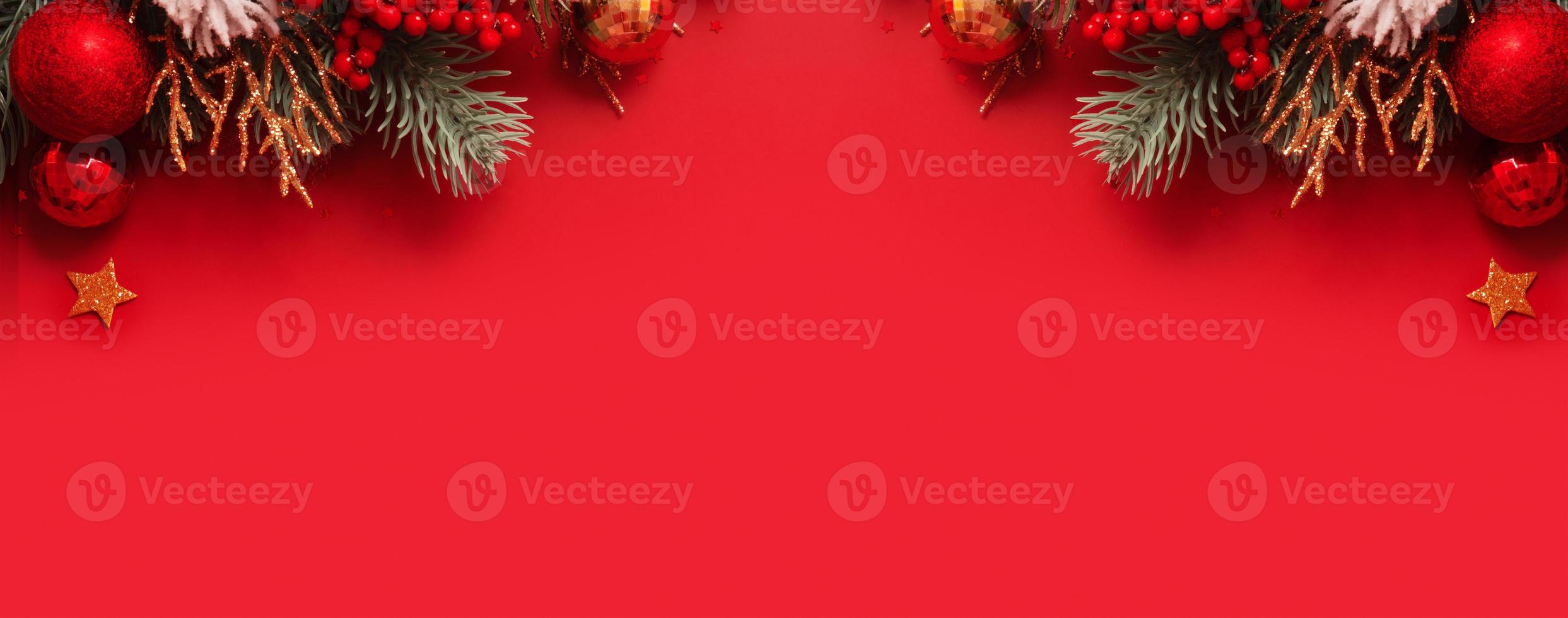 Banner with Christmas decoration and pine tree on red background with copy space. New Year greeting banner. photo