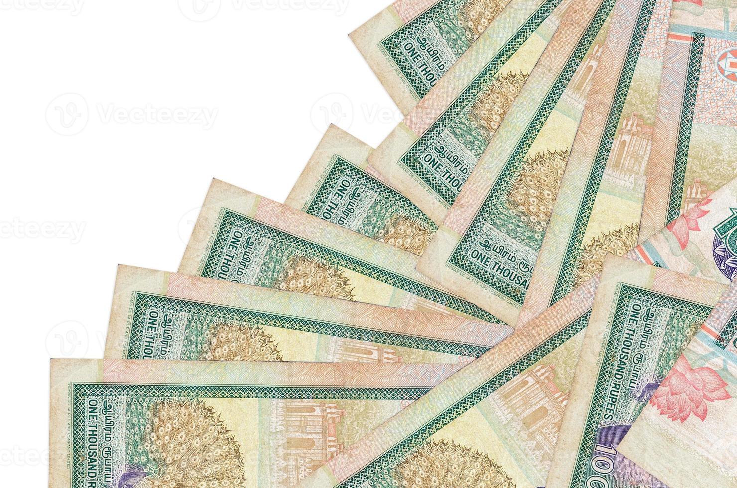 1000 Sri Lankan rupees bills lies in different order isolated on white. Local banking or money making concept photo
