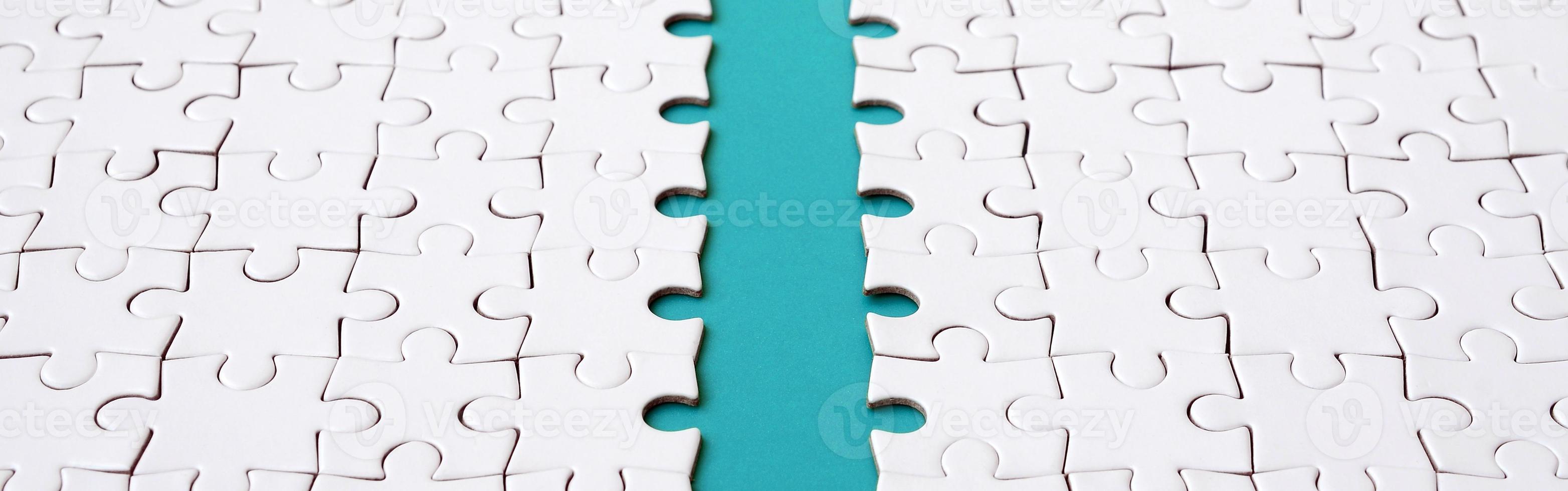 The blue path is laid on the platform of a white folded jigsaw puzzle. Texture image with copy space for text photo