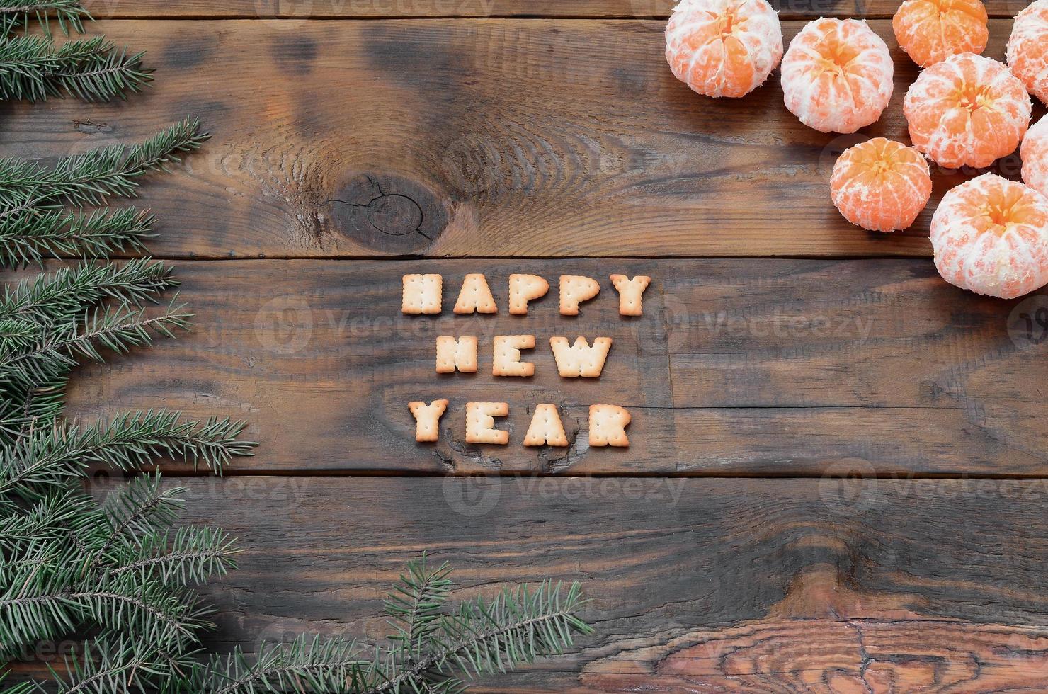 Tangerines, cracker text and fir branches with copy space photo